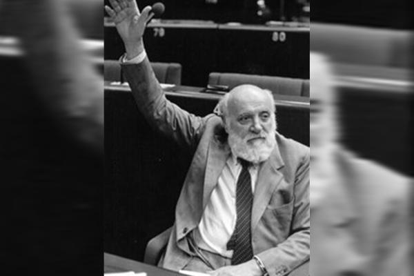 a man with a raised hand to vote
